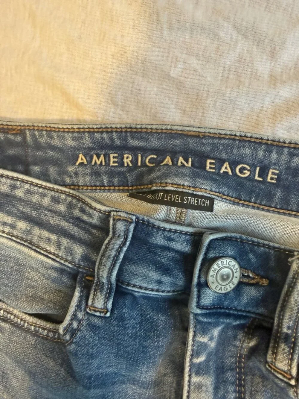 American Eagle hi Rise Jeans Size 4 Medium Blue Cotton Spandex Jeggings Raw Hem
